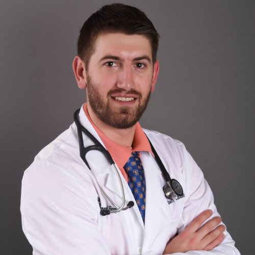 Dr. Shawn Caudle in a white coat with a stethoscope.